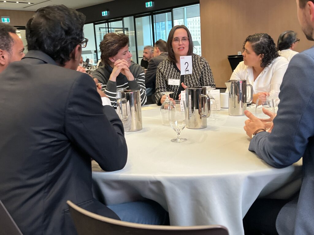 Trina, CEO of Boost Academy of Excellence, mentoring executives over a round table at a networking event