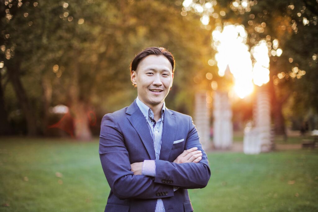 Asian business man dressed in suit standing outside