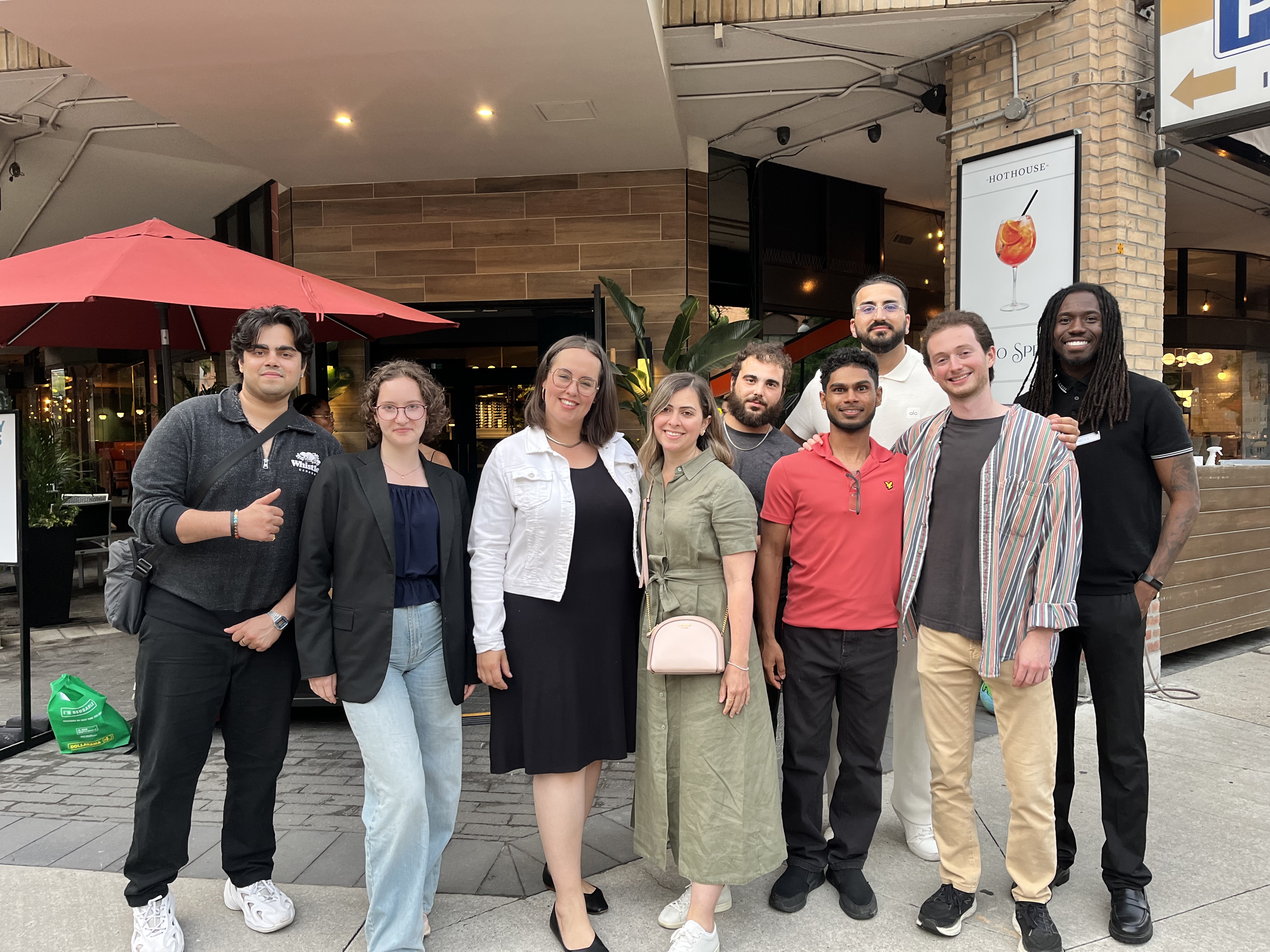 Ten Gen Z professionals posing together at an outdoor meetup in Toronto.